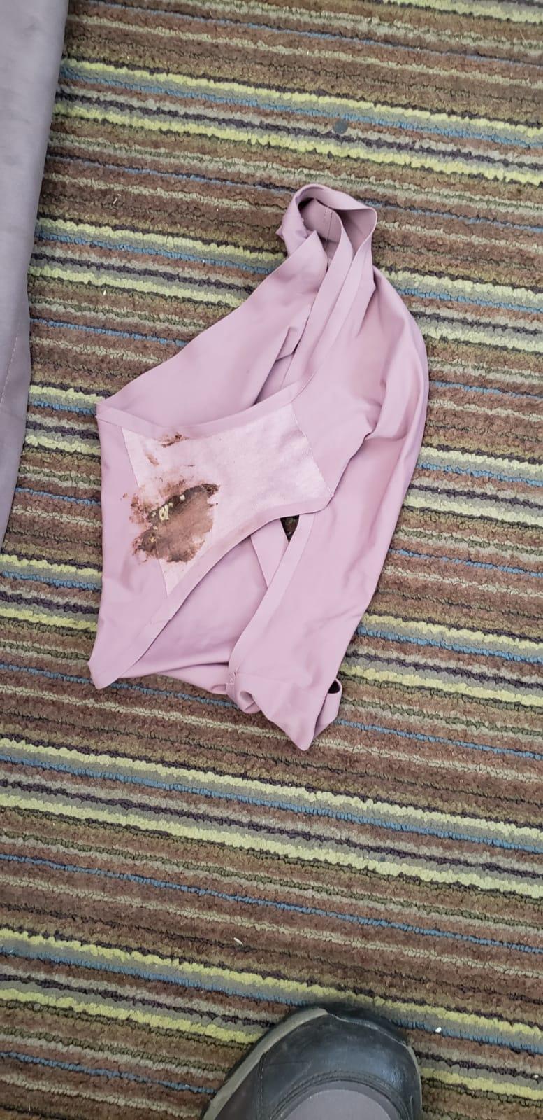 Soiled dirty underwear found under queen bed.