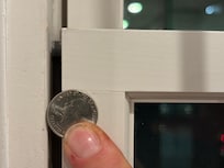 Gap in the window with a quarter shown to give a scale