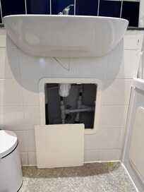 Bathroom with wobbly tap and broken/open underneath