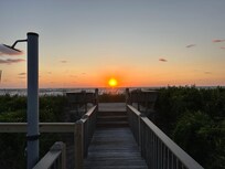 View of ocean from private walk. Private shower and foot wash can be seen on left.