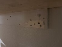 This piece of plywood look like it was part of the half table, but it was screwed on to the wall, but it had like a lot of drywall screws, but when I look closely, there was cameras and there’s two cameras that I saw