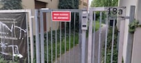 Defaced welcome sign: Graffiti-covered and surrounded by overgrown weeds, clearly showing neglect.
Broken gate lock: Clearly visible damage showing major security risk.