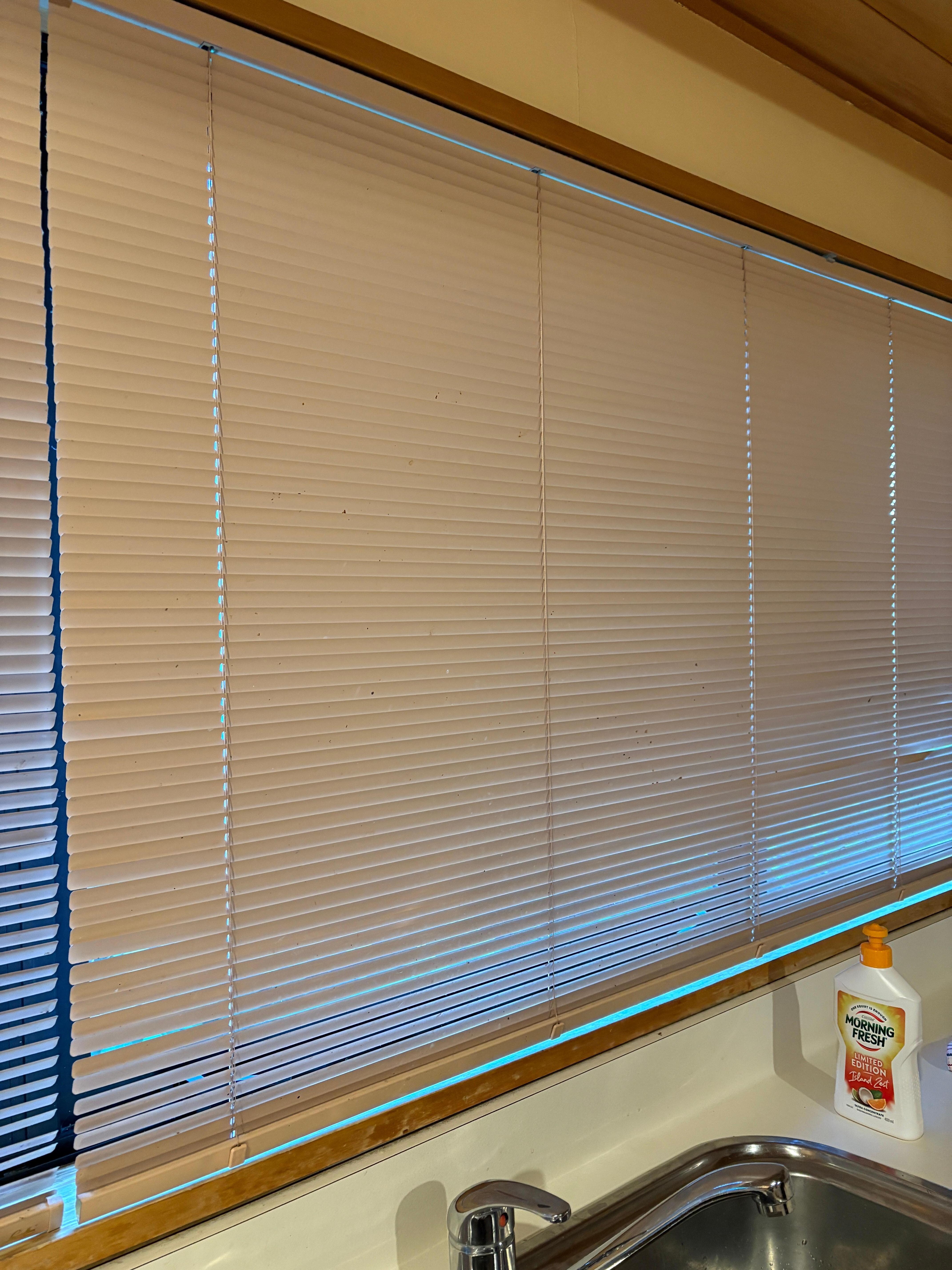 Dirty blinds at the kitchen sink