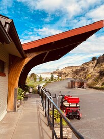 View of front entrance of Celilo Inn with venue in distance