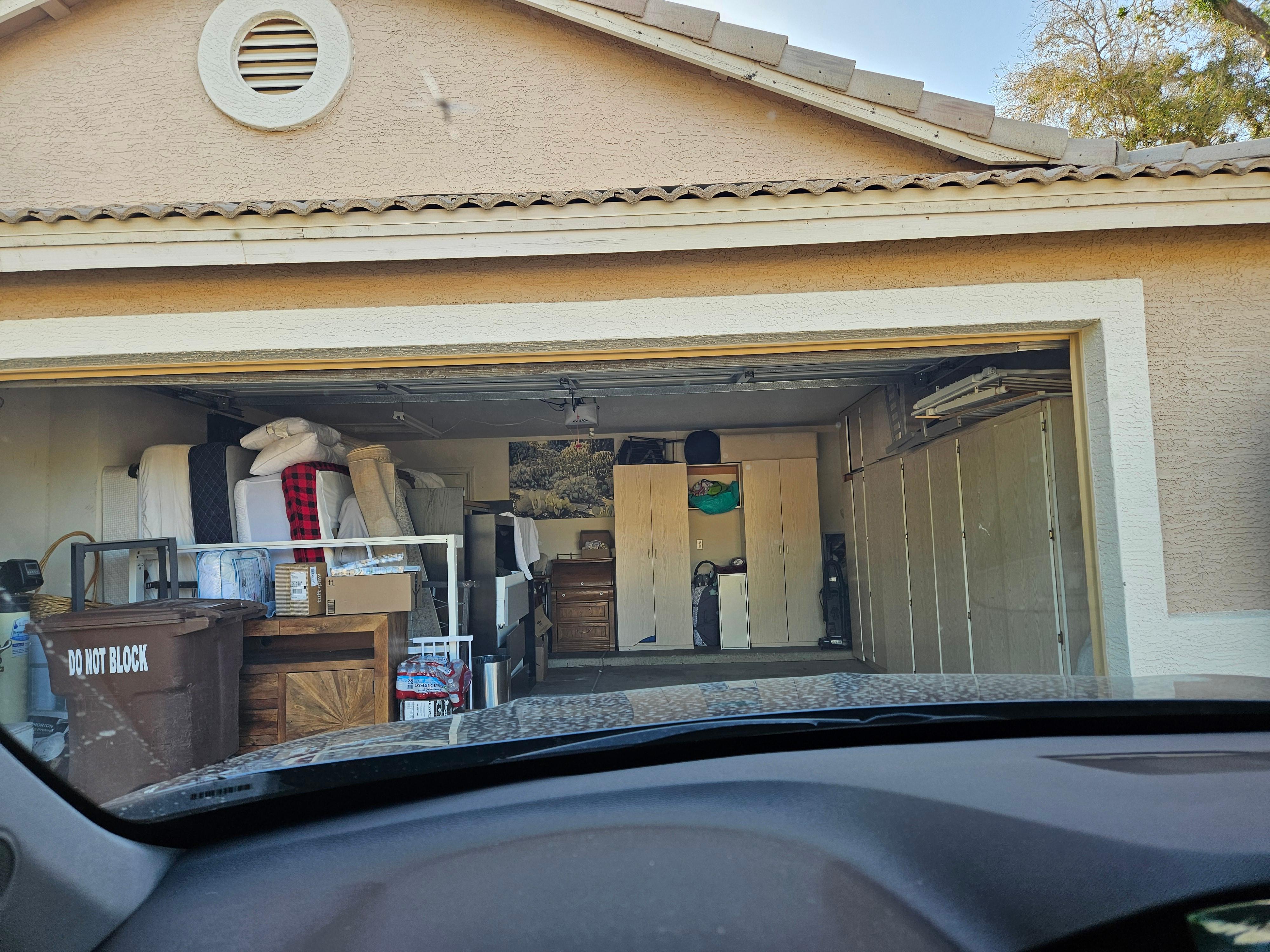 Garage full of items, barely room to park car (compare to listing pics)