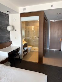 Interesting glass wall bathroom concept. But there is a blind!