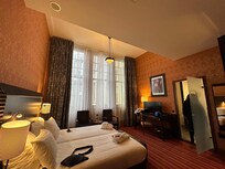 Large room with closet, hangers, drawers, and minibar with complimentary water & soft drinks