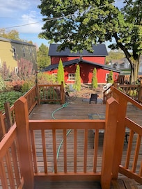 view from kitchen door, showing deck and guest house