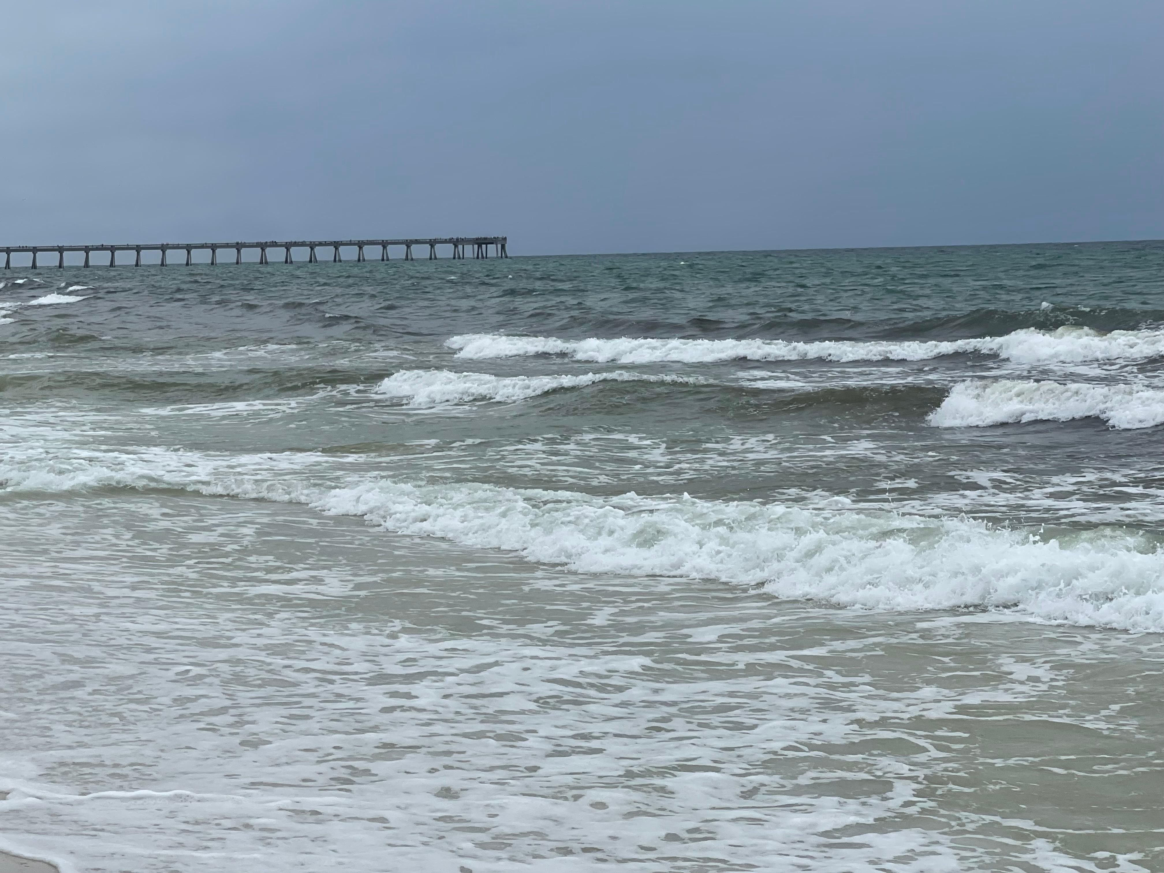 View of pier down the beach