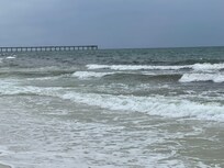 View of pier down the beach