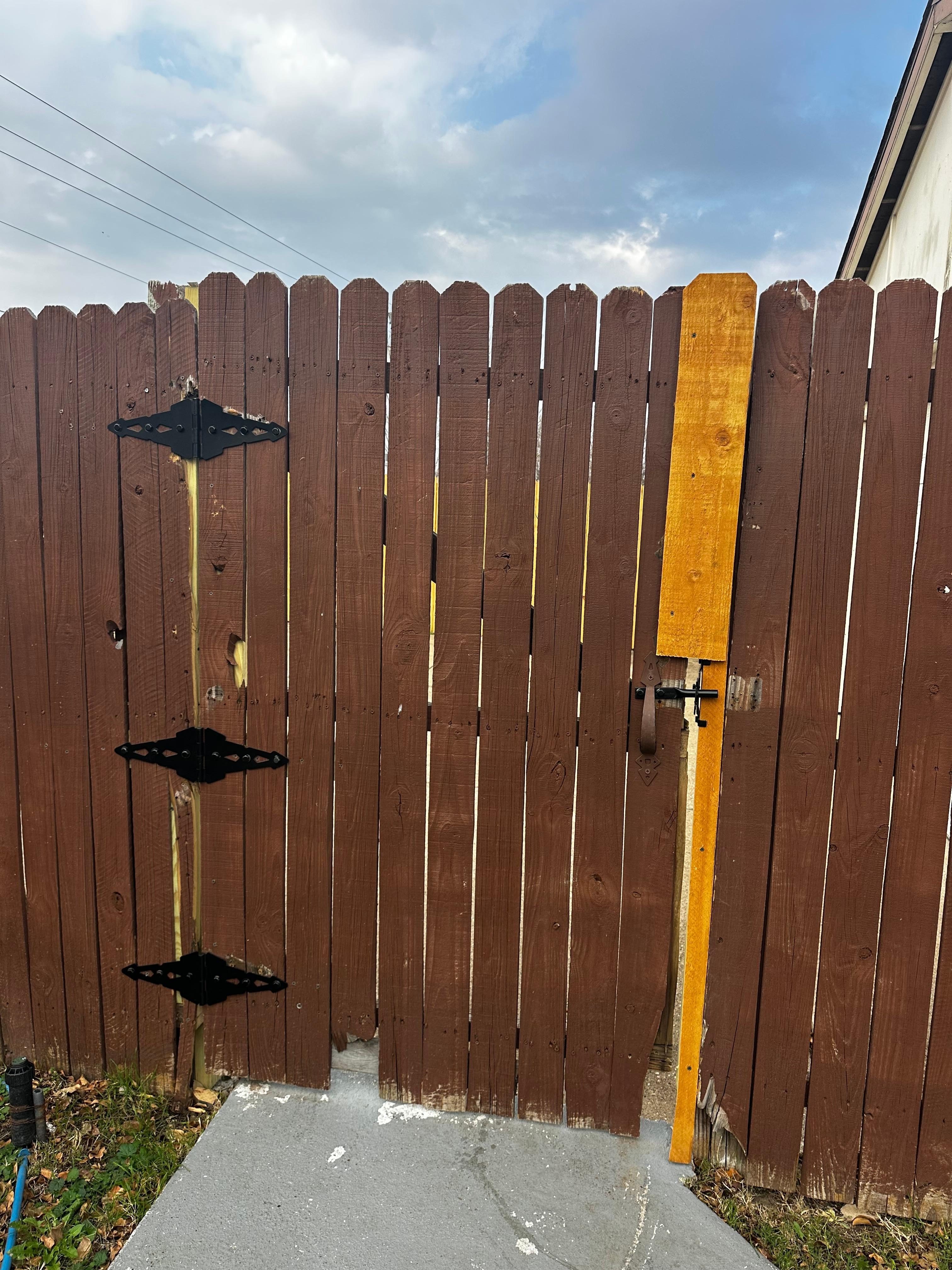 Fence gate opens and closes and looks like a forclosire
