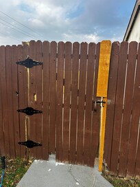 Fence gate opens and closes and looks like a forclosire