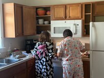 Alleigh making pancakes with Grandma Debbie.