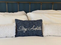 Comfy cozy bedding make you want to stay more than awhile.