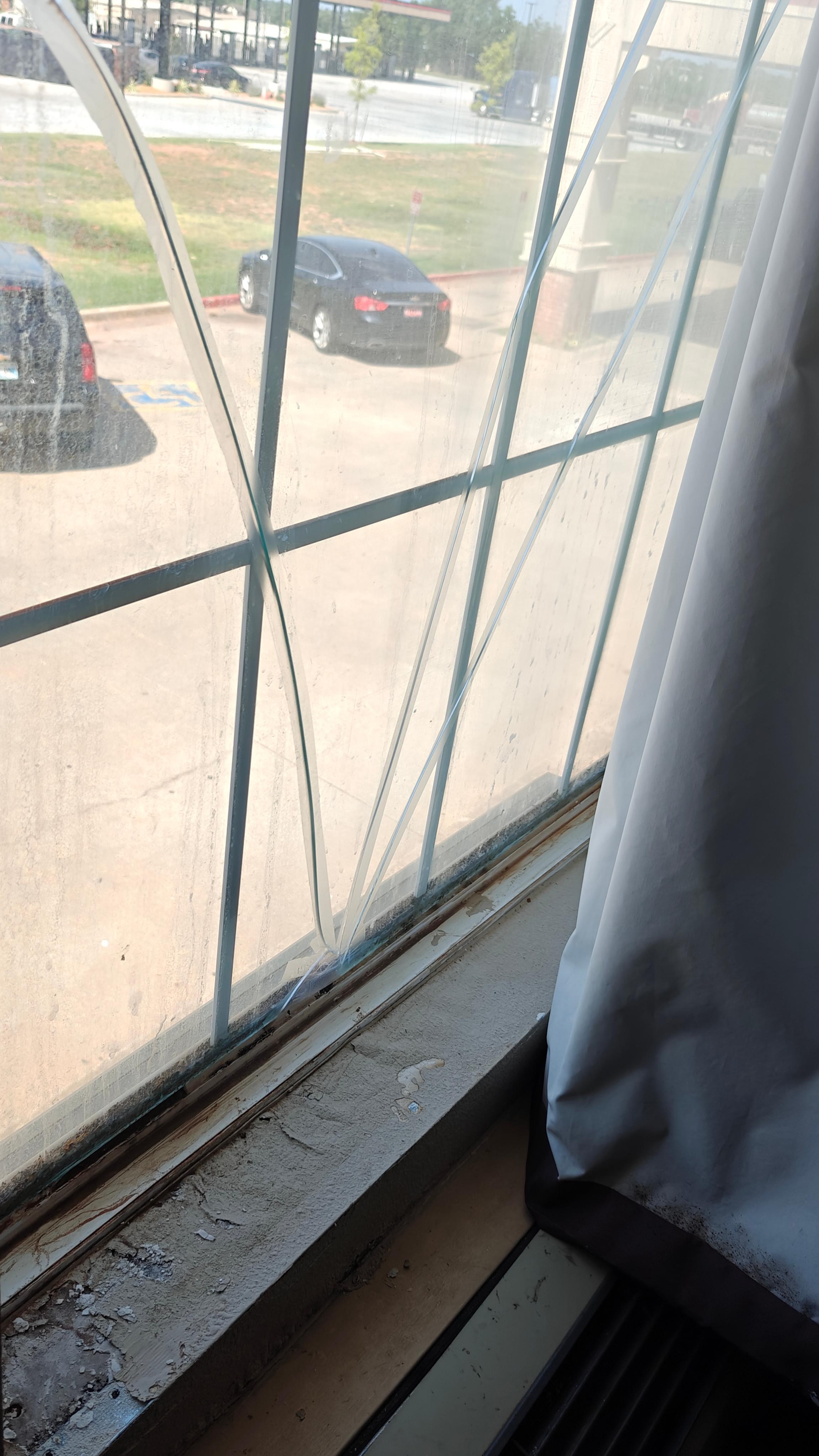 The window curtain had pushpins in it to keep closed. I'm guessing hoping that someone didn't open the curtain and find the mold. The broken glass is held together by clear Scotch tape. 