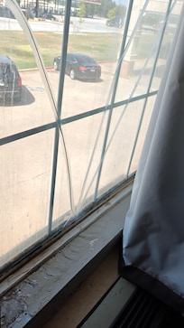 The window curtain had pushpins in it to keep closed. I'm guessing hoping that someone didn't open the curtain and find the mold. The broken glass is held together by clear Scotch tape.