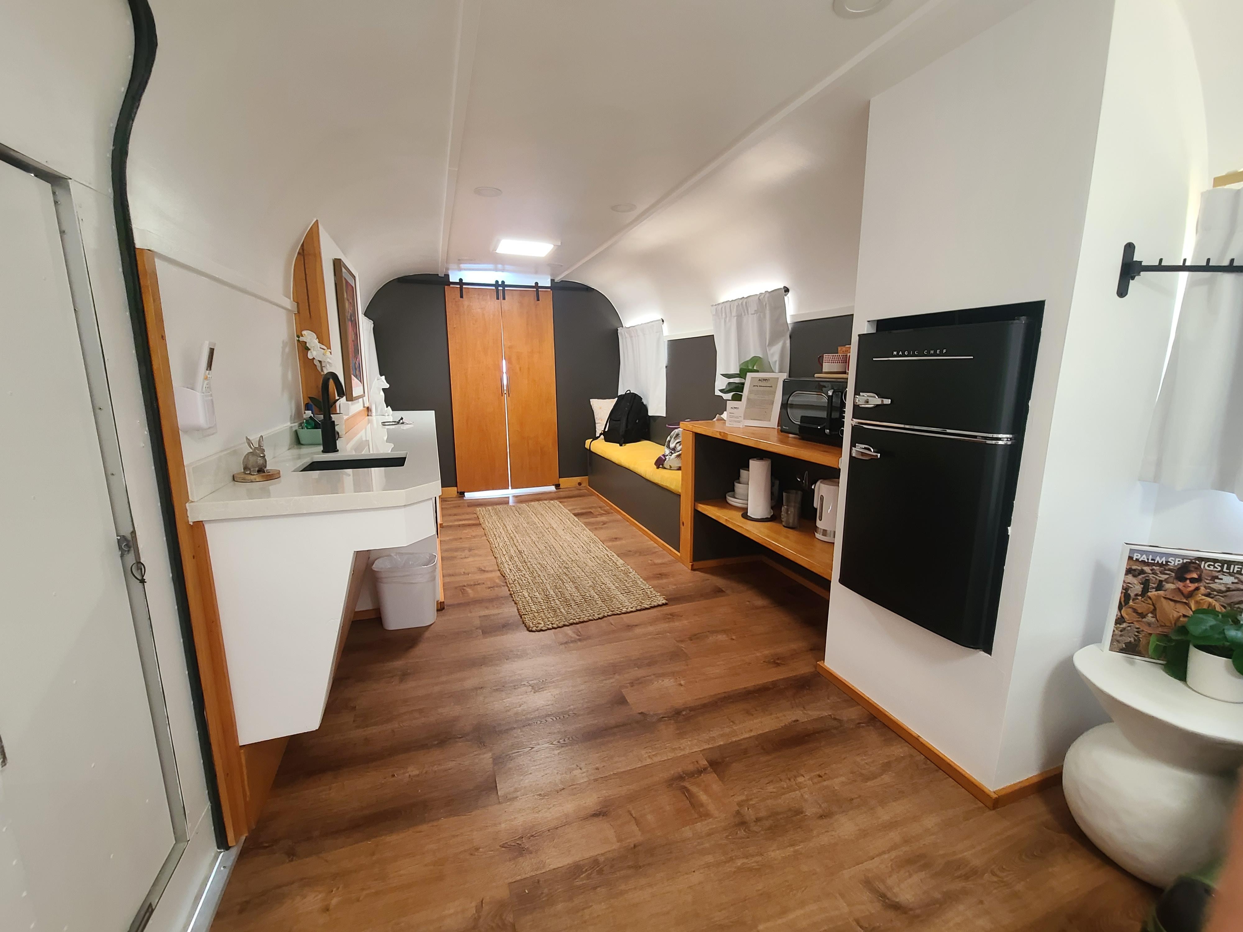 Super cute, lots of bench space, sink, fridge, even came with a fan!!