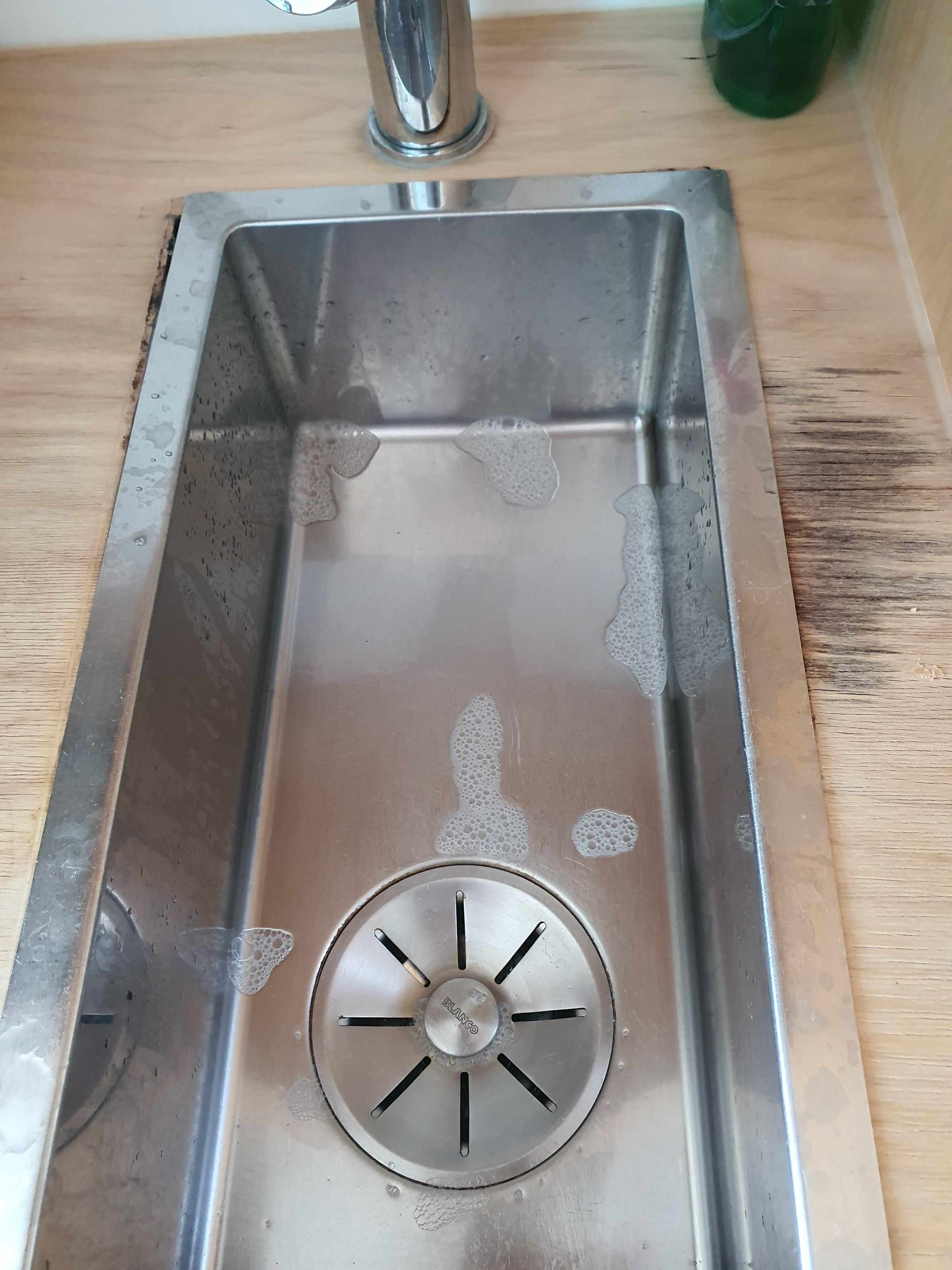 Kitchen sink moved within the bench top cut-out, and was quite dirty around it.