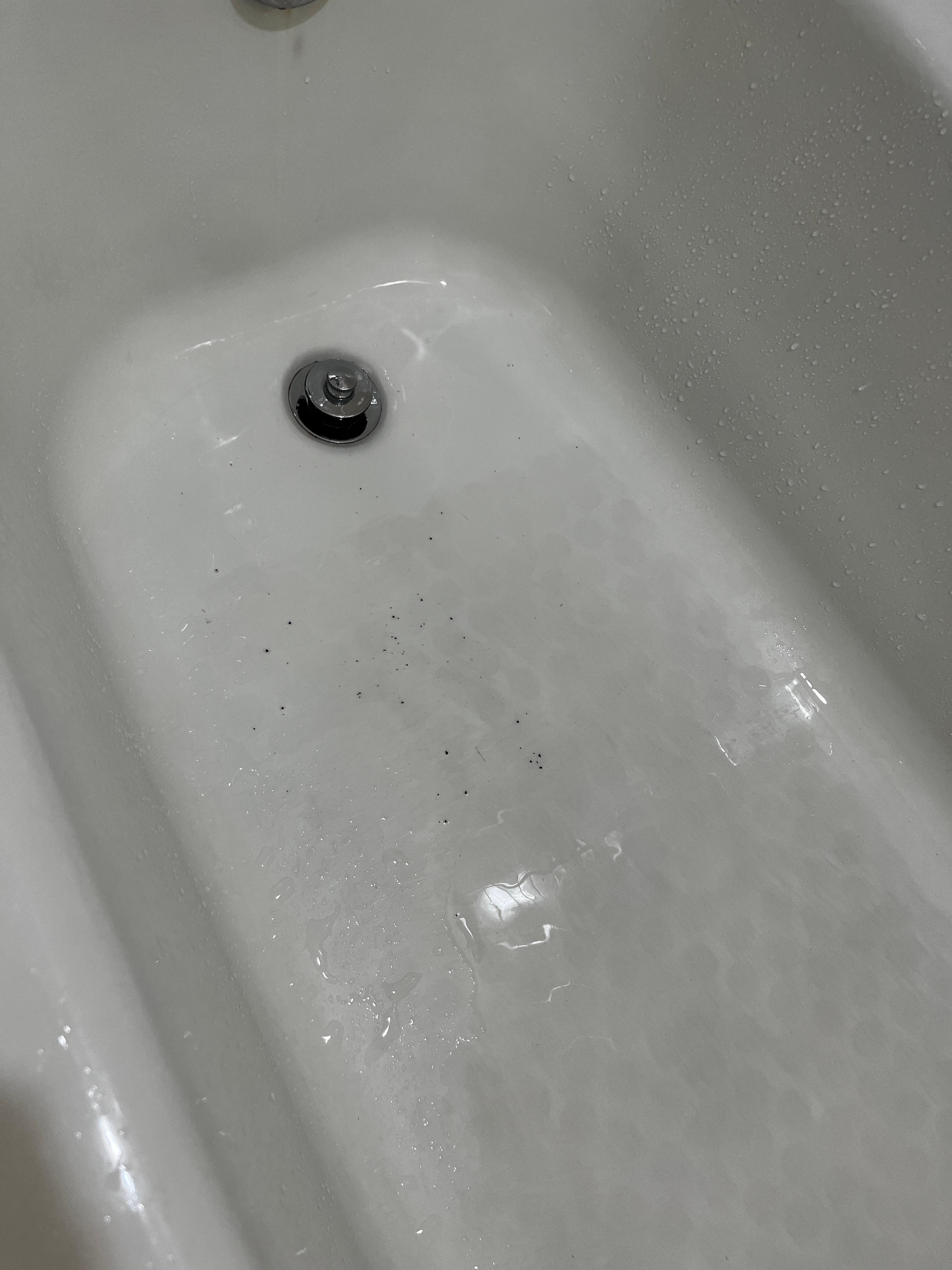 What is that black stuff that blew out of the faucet, mold,  rust? The ceiling was so low I knocked loose a tile raising my arms to change shirts. 