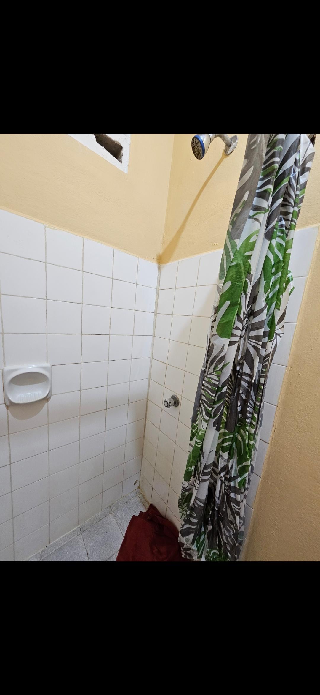 Towel to absorb the sound of the constantly dripping shower. The tiny shower cubicle with the plastic shower curtain created static which meant the dirty old curtain stuck to your skin every time.  