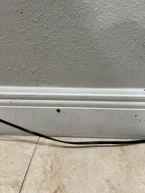 Substance splattered on wall, floor and side table in bedroom. Appeared to be blood