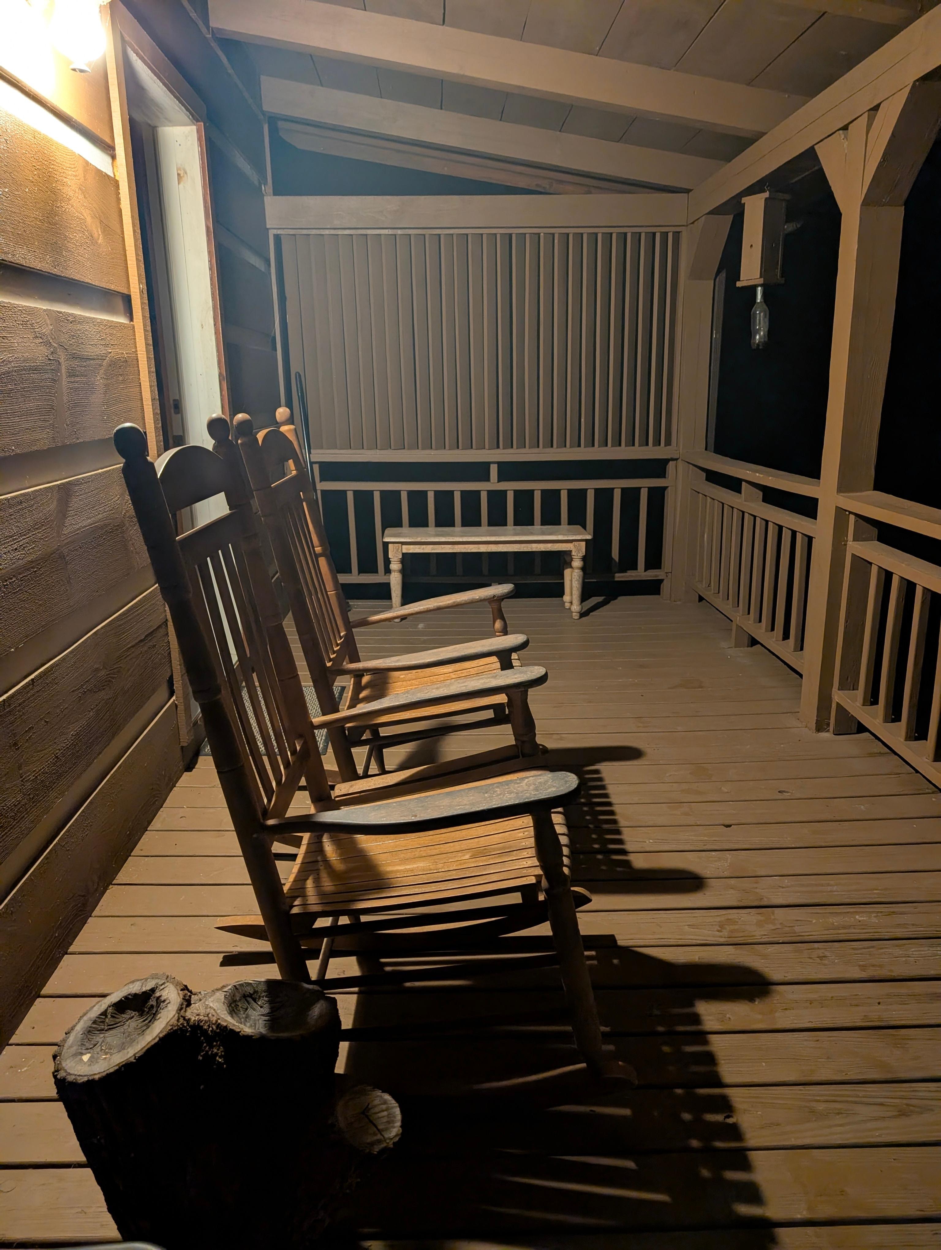 Cozy sitting porch on both sides of the house. This one's out back. 