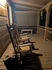 Cozy sitting porch on both sides of the house. This one's out back.