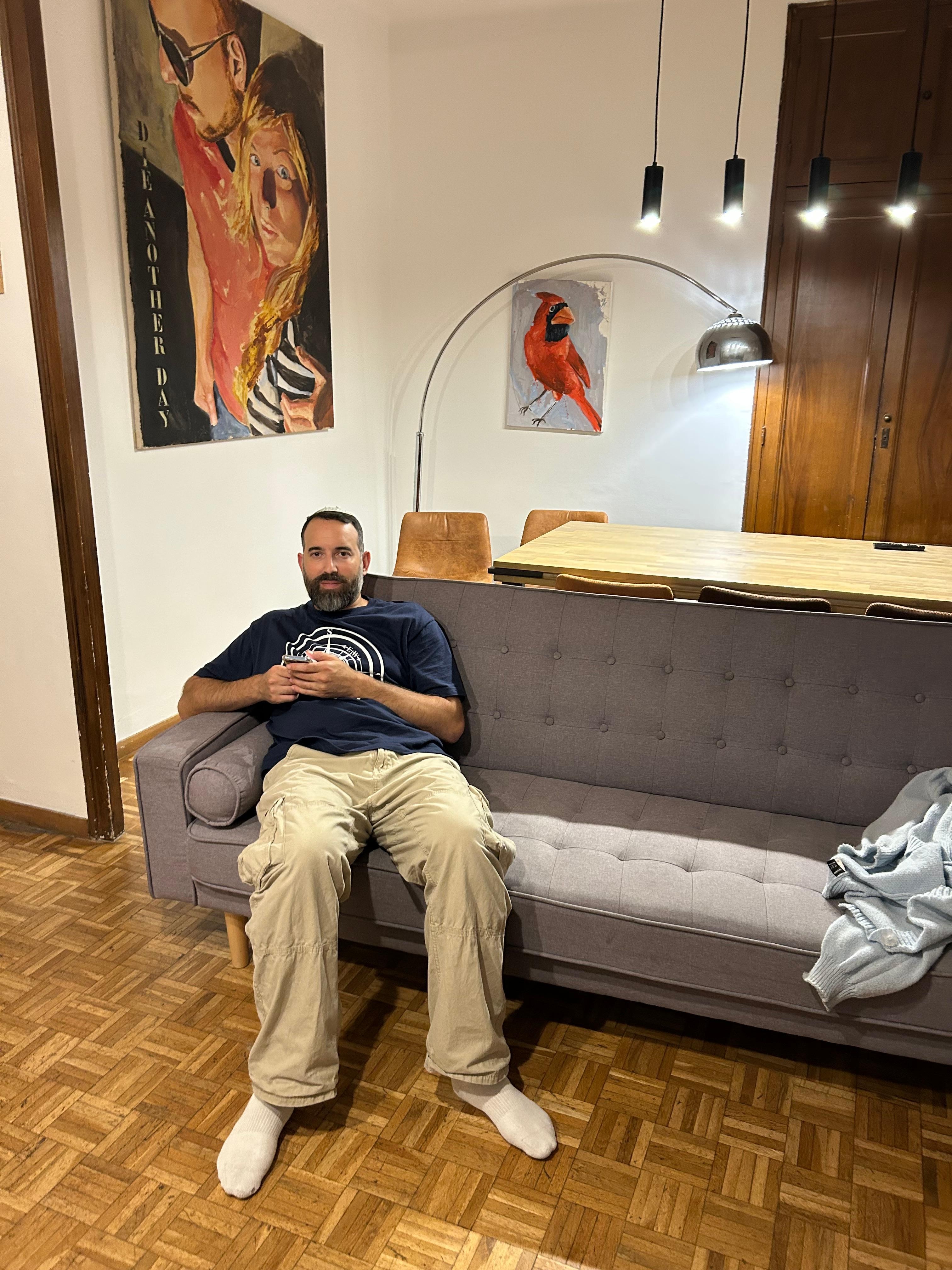 Enjoying the couch in the living room with dining table in background
