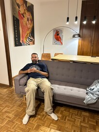 Enjoying the couch in the living room with dining table in background