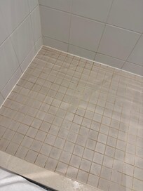 Old dirty grout in shower
