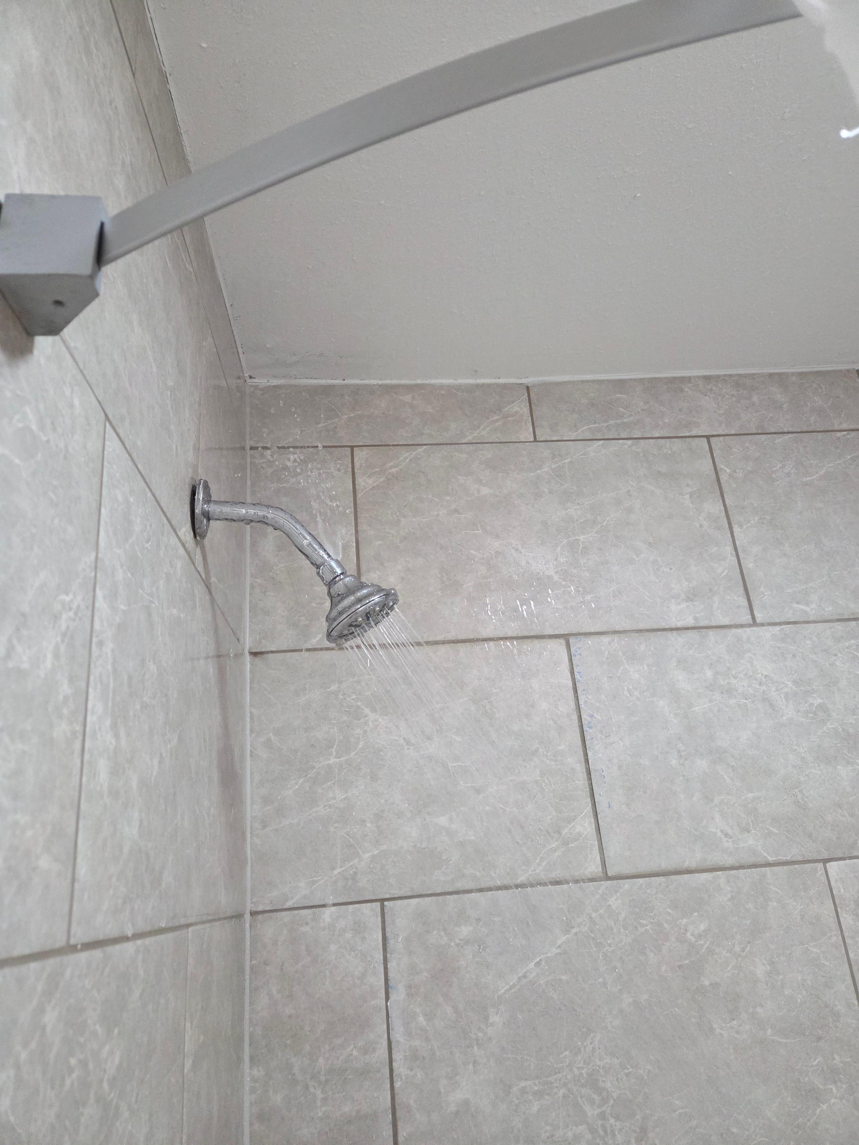 The shower head was leaking on top & the ceiling was getting moisture on it