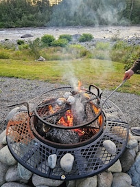 Wood fire pit with grill for cooking.