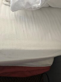 Soiled linen looked like someone stepped on it to get at the ceiling. Hair in the stains