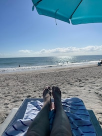 Lounging on beach in front of hotel.