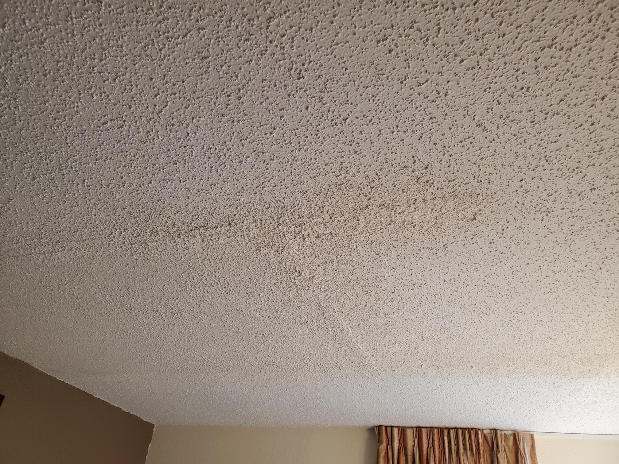 Crack in ceiling as well as clearly visible seems in drywall joints. 