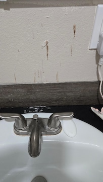 Flooring glue from the vinyl flooring planks used as backsplash.