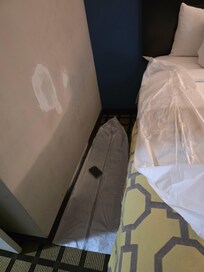 Freshly repaired wall hole and sanding block.