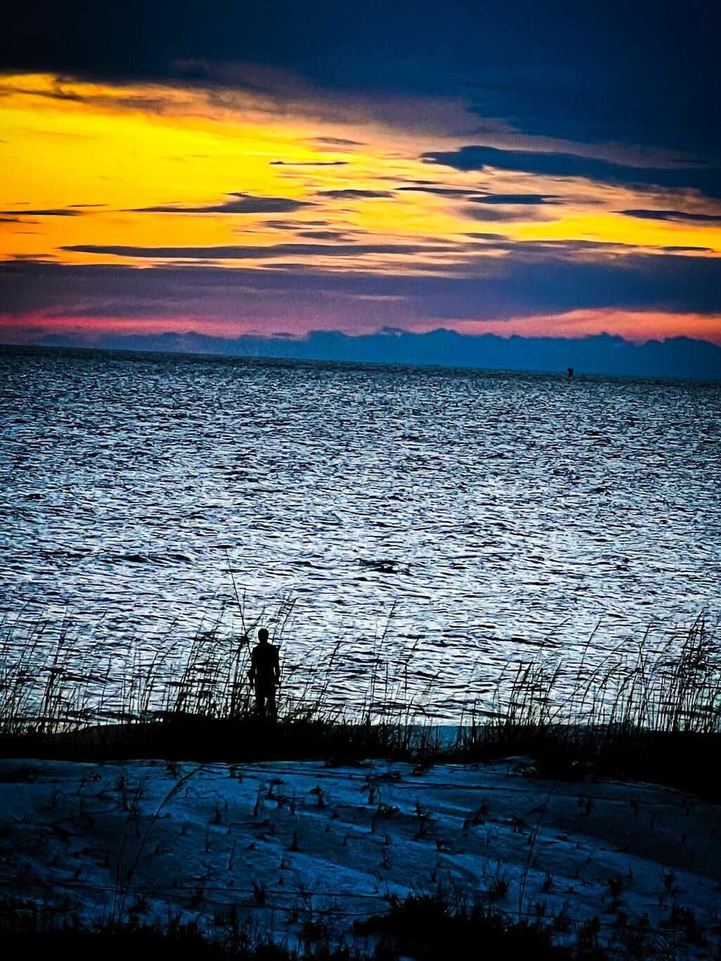 Surf fishing at sunset