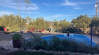 Backyard view overlooking the covered pool
