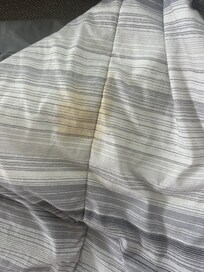 Pet stains and a very strong smell. I couldn’t even use it to cover up with at night.. I had to place it aside and only use a small fleece blanket that was provided. Wasn’t sufficient to cover 2 people.