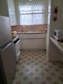Full kitchen with refrigerator, oven, stove-top, microwave & coffee maker with coffee, tea, sweetener & powdered cream provided.