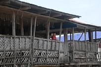 A friendly child waving to a photographer