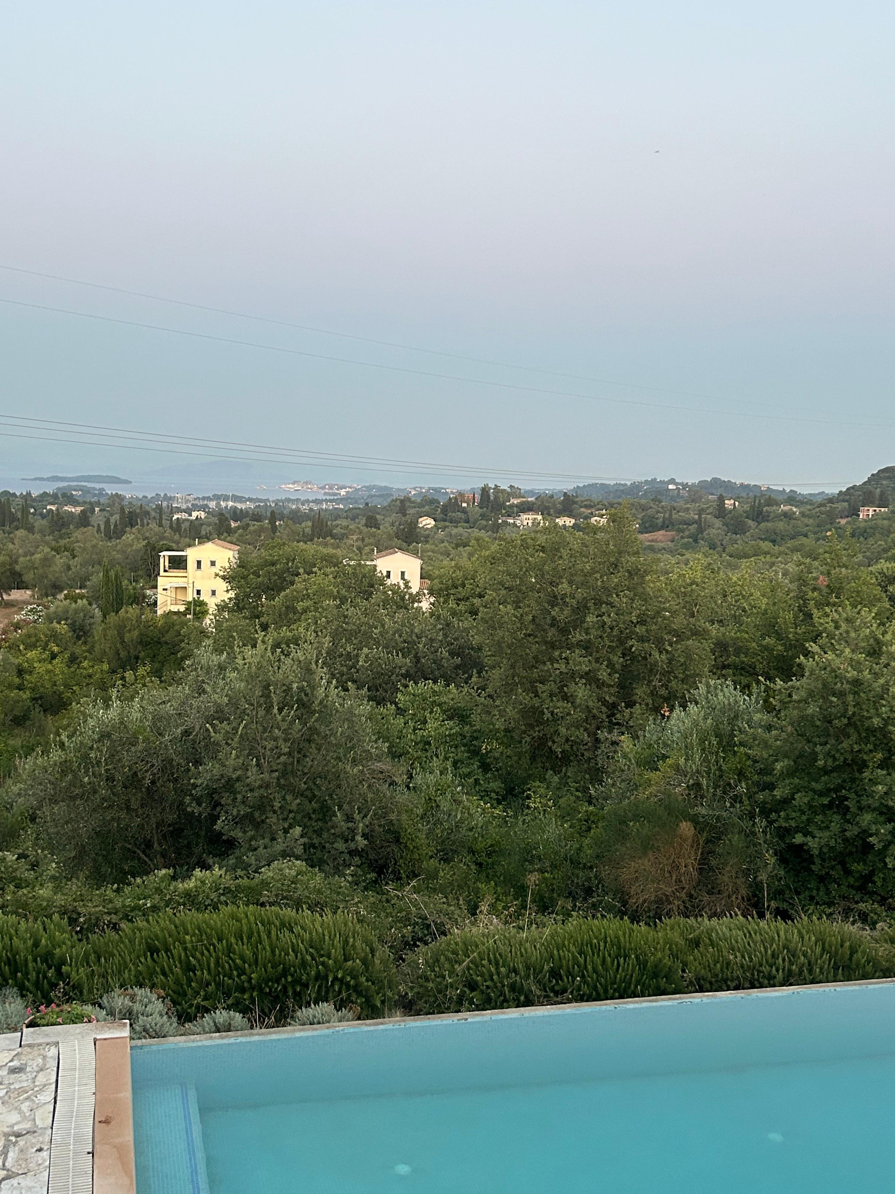 View from the veranda across the landscape to the sea, with the pool just below.
