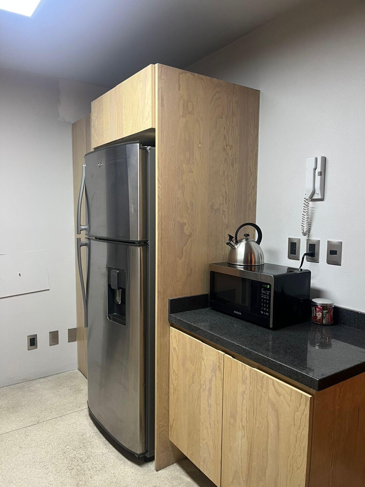 Big fridge, microwave and inside the cabinet, a toaster and blender