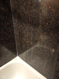 Soap scum all over the walls of the shower