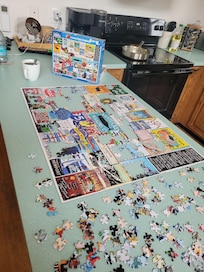 Doing a puzzle on the kitchen counter with my coffee before breakfast