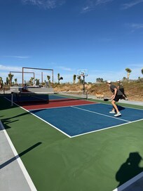 Pickle ball courts with hot tub and small pool behind that.