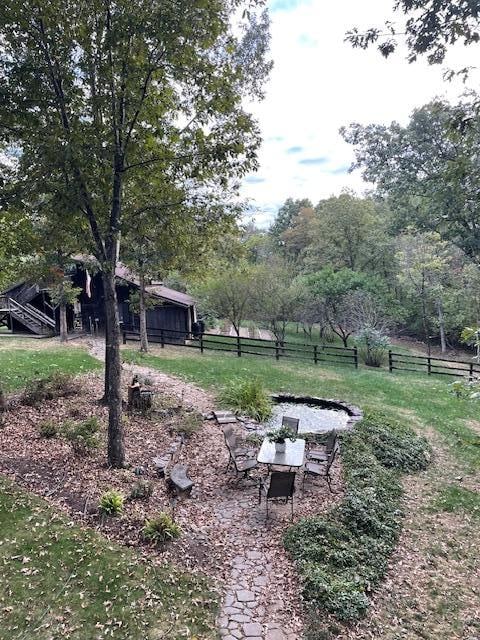 pond, fountain, table with the house's barn & garden in view. We played board games & had happy hour out here and as well as in the screened porch. 