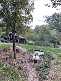 pond, fountain, table with the house's barn & garden in view. We played board games & had happy hour out here and as well as in the screened porch.