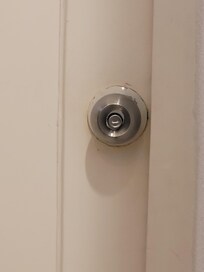 Bathroom doorknob is too
close to wall